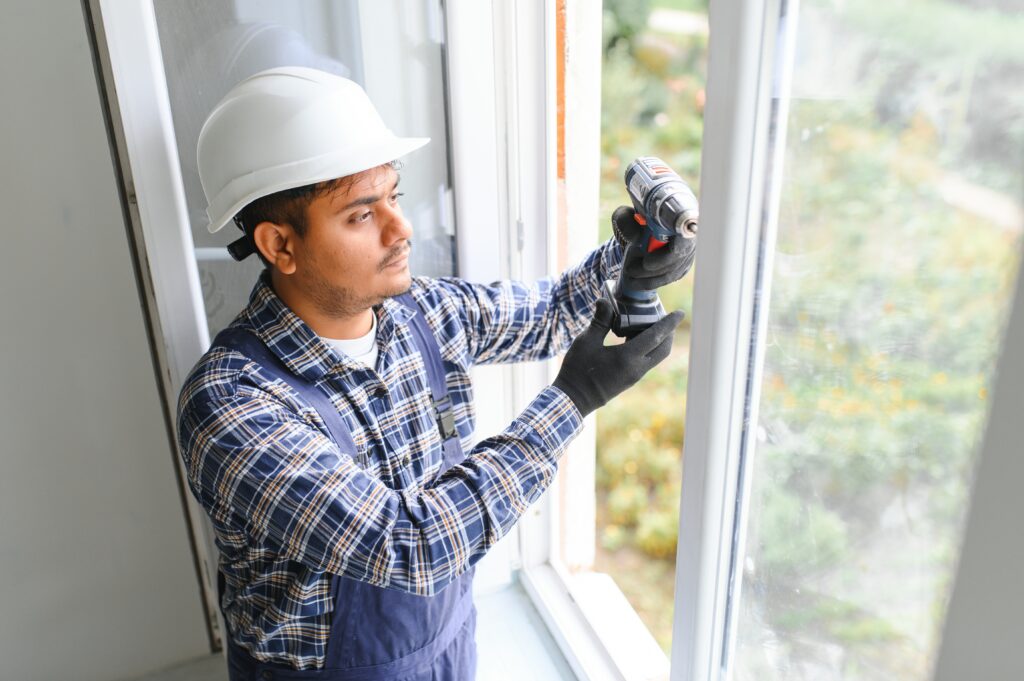 Groves Glass LLC technician replacing broken window pane at a residential home