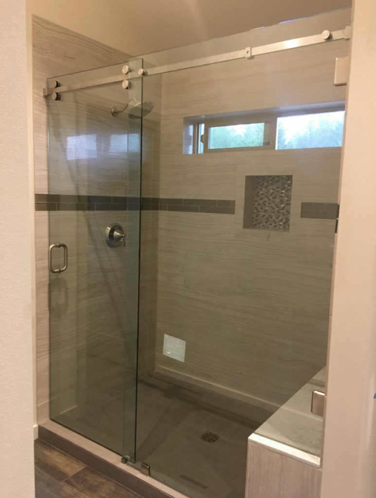 Frameless glass shower door installed in tiled bathroom, Port Townsend WA